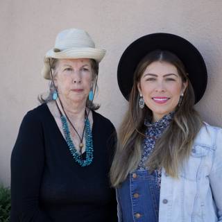 Two Women in Hats and Overalls