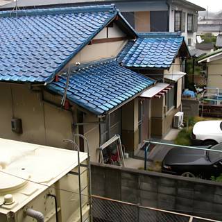 Blue Roof House with Parked Car