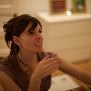 Penelope Engaged in Animated Conversation at Gallery