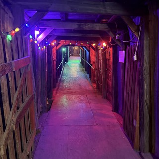 Illuminated Wooden Tunnel with Colorful String Lights