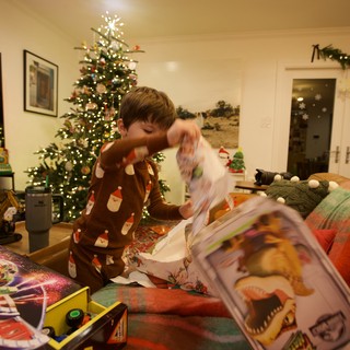 Child Opening Christmas Presents on Christmas Morning