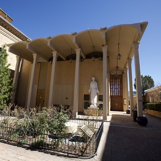 Modernist Catholic Church Entrance with Curved Canopy Architecture