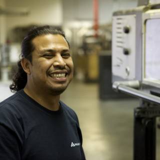 Man with a Smile in Front of Electronic Monitor