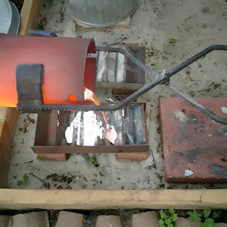 A Red Pot on a Metal Grate
