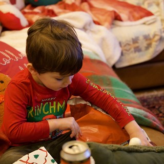 Child Opening Christmas Gift on Holiday Morning