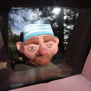 Whimsical Character Head Display in Pink Frame