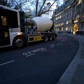 Concrete Mixer Truck Navigating Curved London Street at Dusk