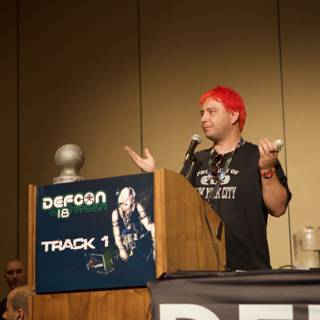 Red-haired speaker addresses crowd at DefCon 18