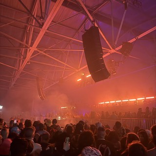 Skrillex Concert in Atmospheric Fog and Neon Lighting