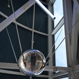 Reflective Satellite Sphere Suspended in Modern Atrium