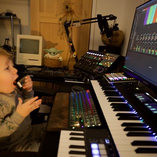 Young Child Explores Music Production Studio Setup