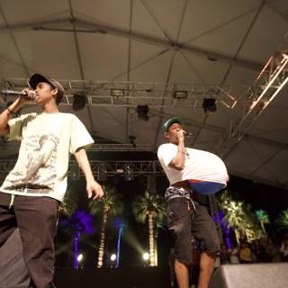 Tyler, The Creator performing on stage with a friend