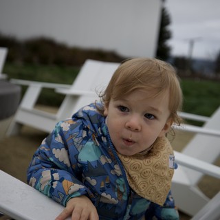 Toddler in Blue Patterned Jacket at Outdoor Dining