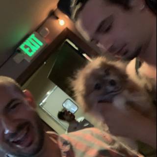 Two men and their furry bar buddy
