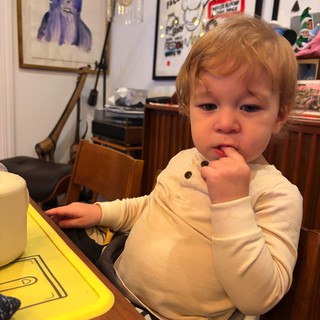 Toddler's Thoughtful Moment in Artistic Living Space