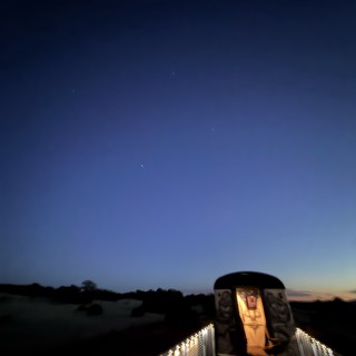 Twilight Memorial: Illuminated Walkway Under Evening Stars