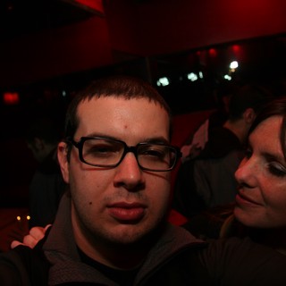 Two Friends Posing at a Dimly Lit Nightclub