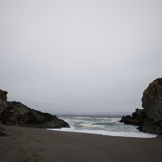 Moody Coastal Cove Between Ancient Sea Rocks