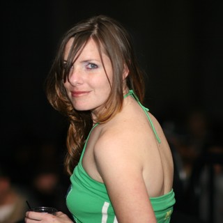 Woman in Green Halter Top at Evening Social Event