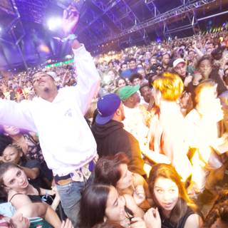 Man in White Shirt Surrounded by Crowd at Coachella