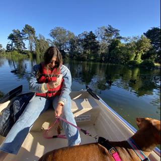 Woman and her Dog Enjoying a Leisurely Canoe Ride on the Lake