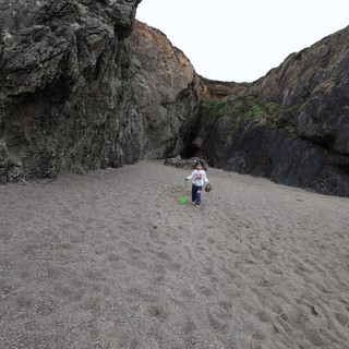 Young Explorer Roaming a Secluded Rocky Cove