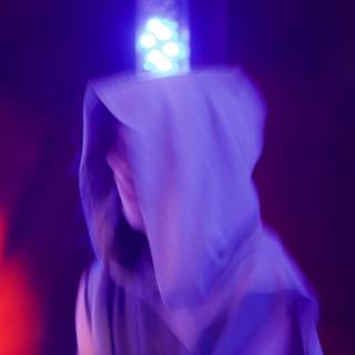 Hooded Figure Caught in Red Light