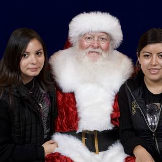 Santa Claus and Two Girls Celebrate Christmas