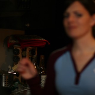 Barmaid in Blue Jersey Behind the Bar