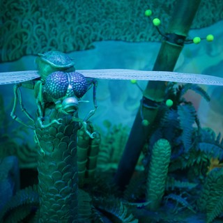 Iridescent Dragonfly Sculpture in Mystical Garden Setting