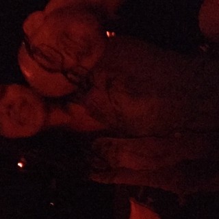 Two Friends Sharing a Moment in Red-Lit Darkness