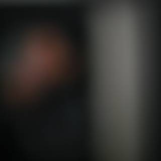 Blurry figure in dim lighting