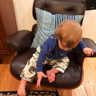 Toddler Exploring Modern Lounge Chair at Home