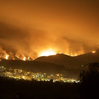 Flames Engulf Hills Above Cityscape