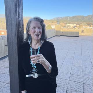 A Content Woman Enjoying a Glass of Wine Outdoors