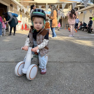 Toddler on Balance Bike at Community Event