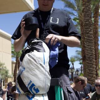 Man in Black Shirt at DefCon with Crowd and Palm Trees in Background