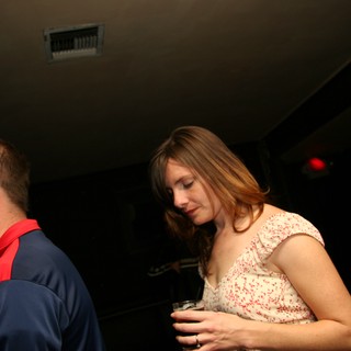 Woman with Drink Lost in Thought at Nightclub