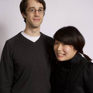 Smiling Couple in Jackets and Glasses