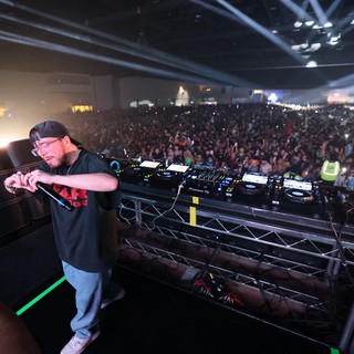 DJ Commands Massive Indoor Festival Crowd from Stage