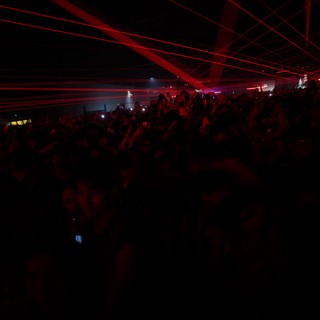 Red Laser Storm Over Pulsing Festival Crowd