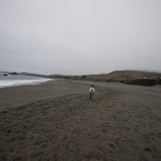 Child Running Free on Foggy Northern California Beach