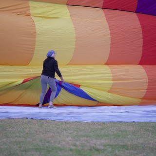 Ground Crew Prepares Rainbow Hot Air Balloon for Launch