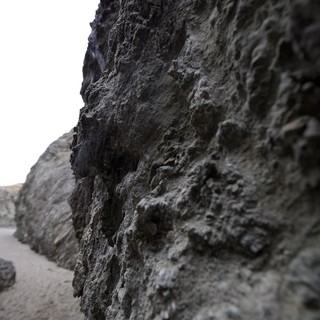 Rugged Coastal Rock Face at Low Tide Beach