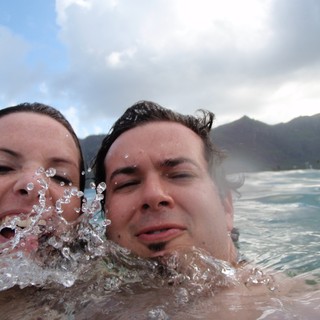 Couple Laughing in Hawaiian Ocean Waves