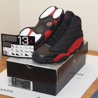 Air Jordan 13 Retro Black Red Sneakers on Hardwood Floor