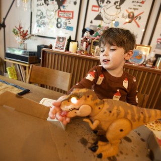 Child Playing with Stuffed Tiger Toy at Christmas Dinner Table