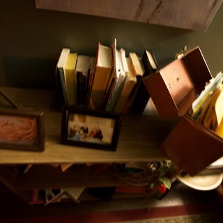 Disorganized Book Collection on Wooden Shelf
