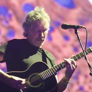 Roger Waters strums guitar at Coachella
