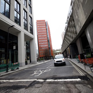 Modern Urban Street Scene with Red Brick Tower